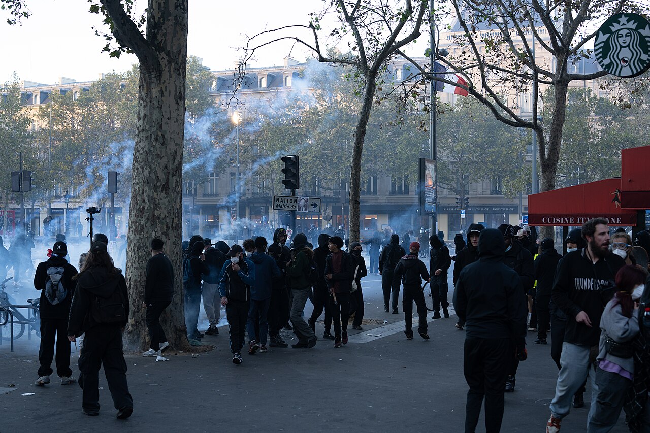 Crowd and tear gas at Place de la République, Paris; full photo credit in the article